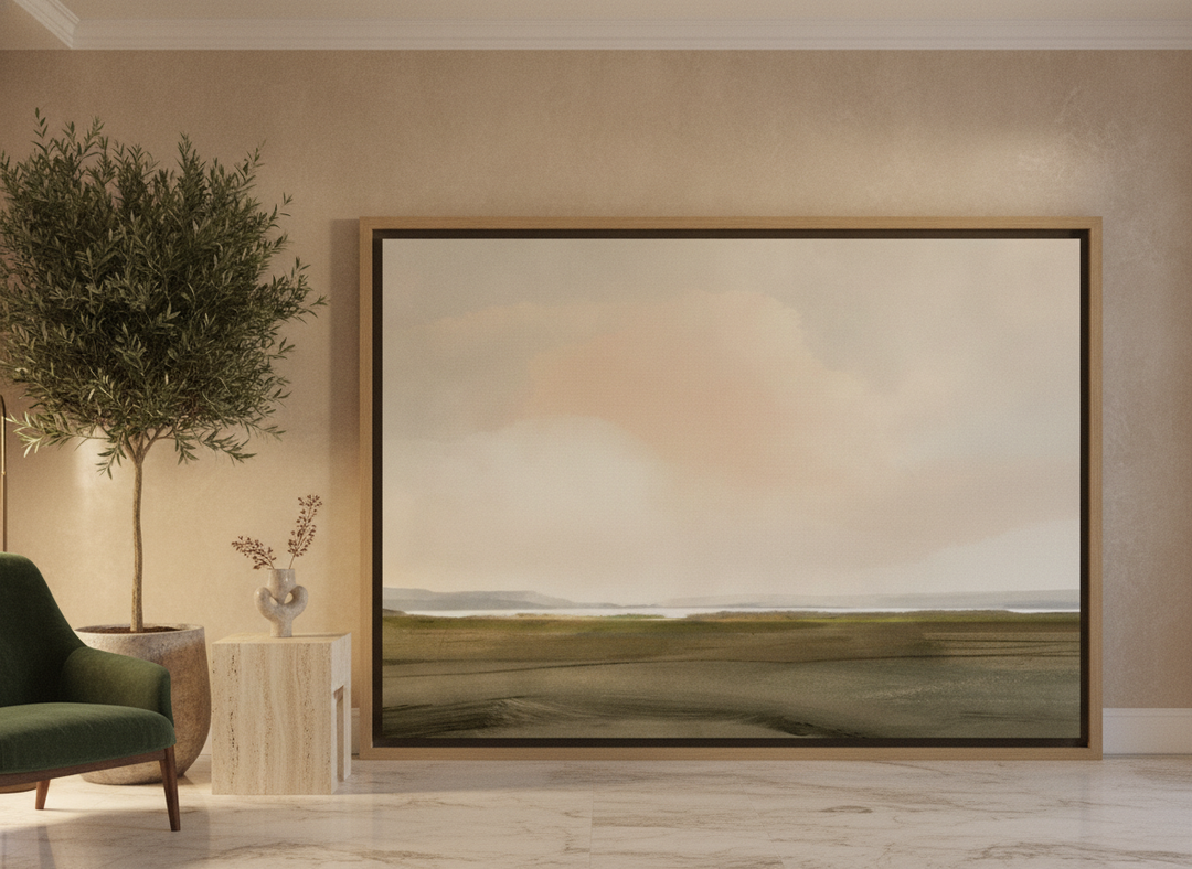 Oversized statement canvas wall art with a natural timber surround leaning against the wall in a luxe living room
