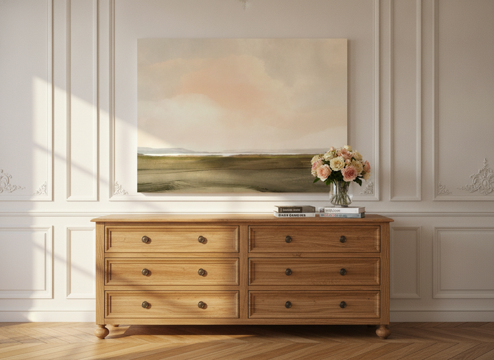 Stretched canvas wall art standing on a sideboard in a Parisian home office