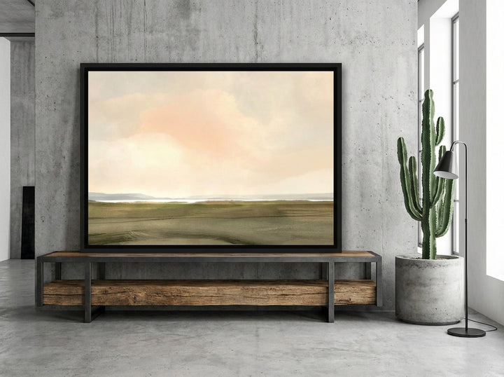 Canvas wall art with a black surround standing on a console in an industrial loft living room