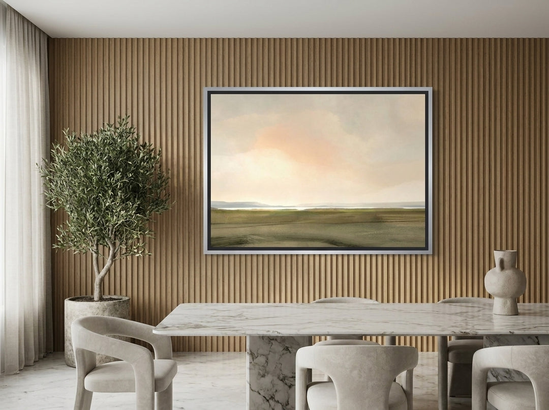 Oversized statement canvas wall art with a silver leaf surround styled on the wall in a luxe dining room
