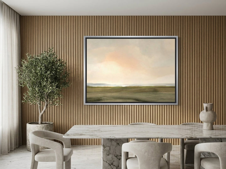 Oversized statement canvas wall art with a silver leaf surround styled on the wall in a luxe dining room