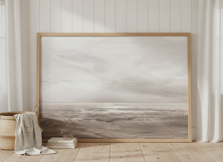 Oversized statement modern wall art print leaning against the wall in a coastal bedroom