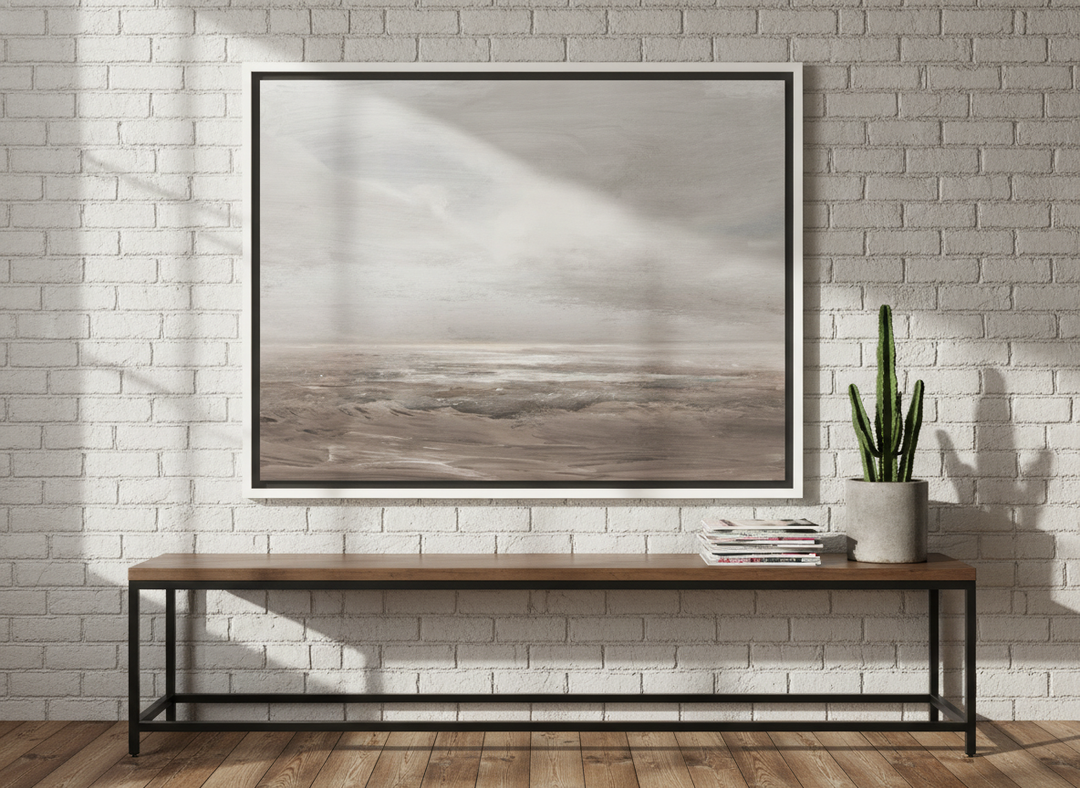 Canvas wall art with a white surround standing on a console in an industrial loft home office