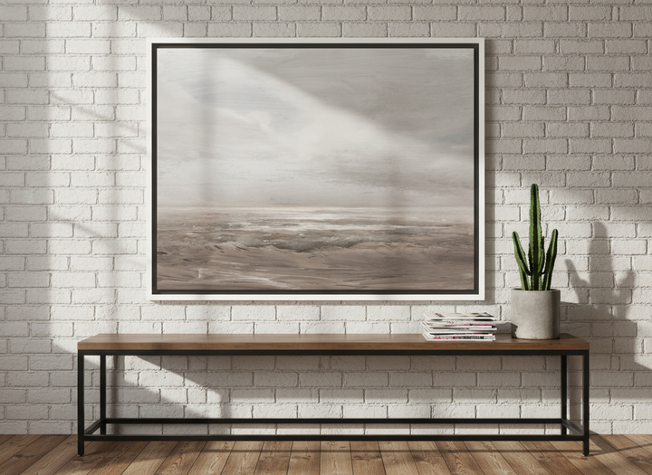 Canvas wall art with a white surround standing on a console in an industrial loft home office