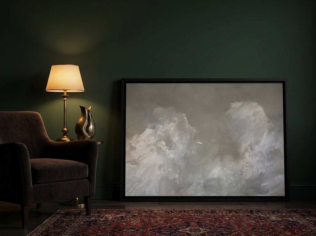 Canvas wall art with a black surround leaning against the wall in a moody living room