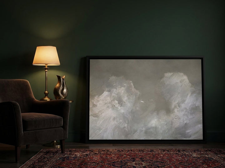Canvas wall art with a black surround leaning against the wall in a moody living room