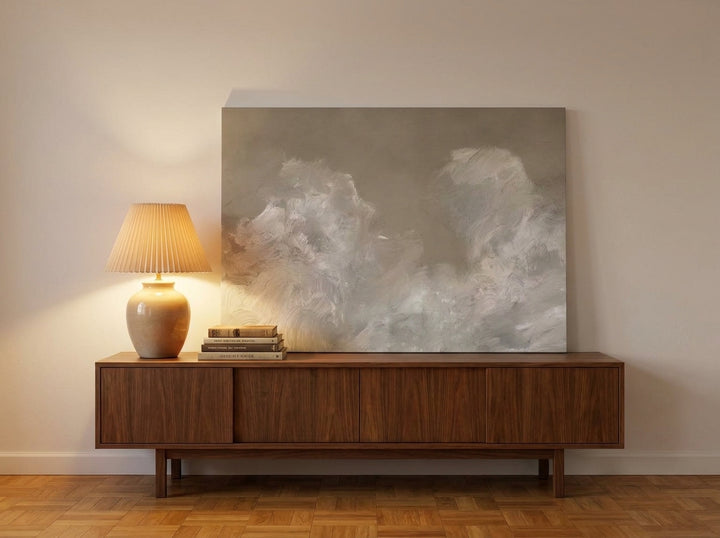 Stretched canvas wall art standing on a sideboard in a mid-century home office
