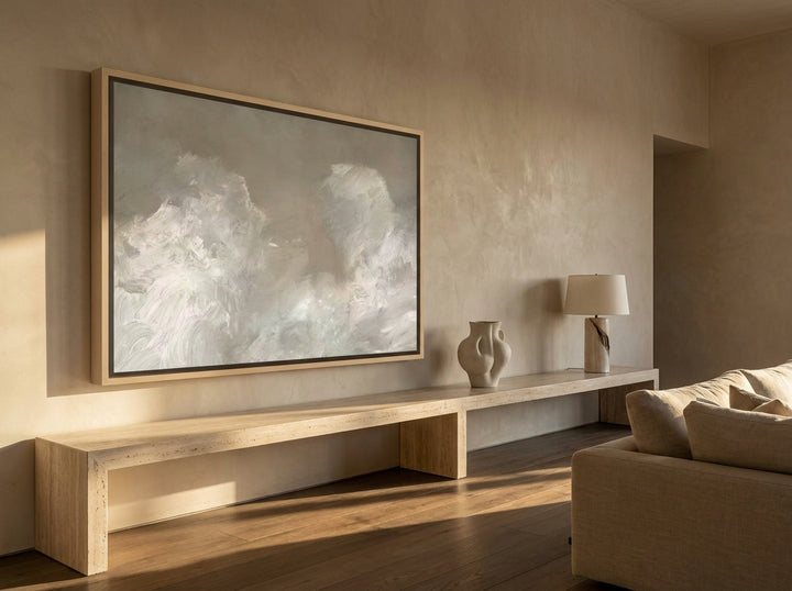 Oversized statement canvas wall art with a natural timber surround styled on the wall in a luxe living room