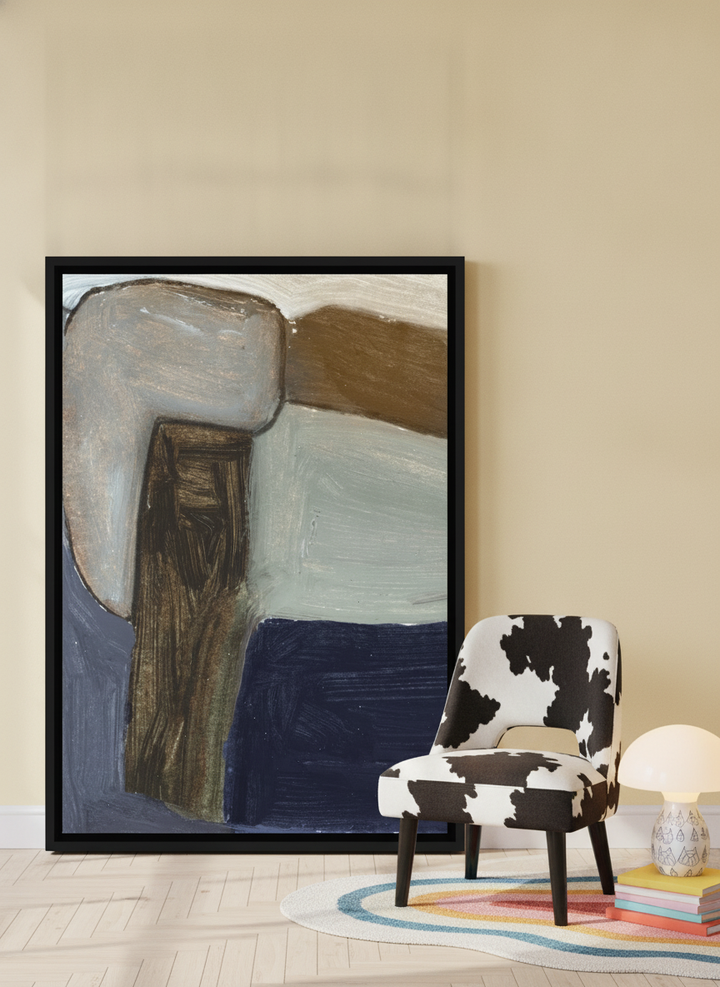 Canvas wall art with a black surround leaning against the wall in a colourful eclectic living room