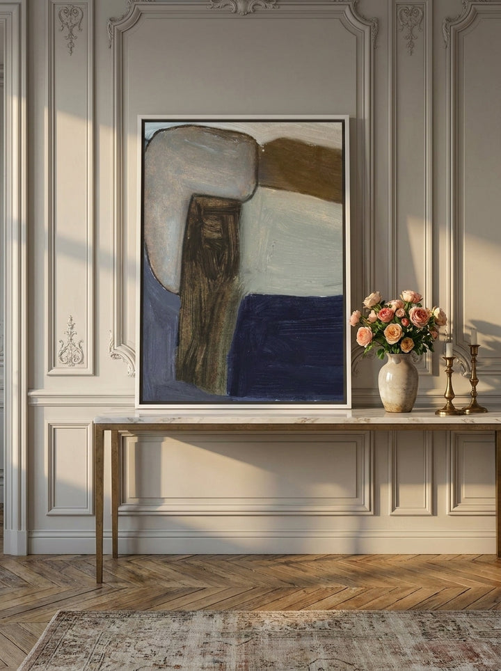 Canvas wall art with a white surround standing on a console in a Parisian home office