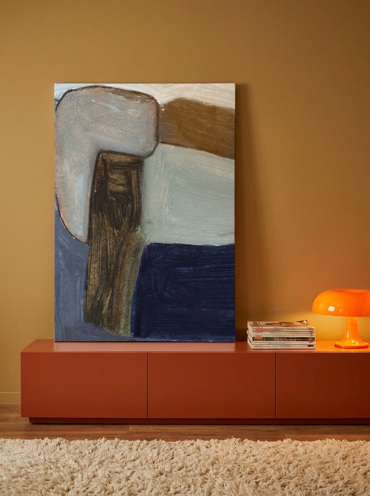 Stretched canvas wall art standing on a sideboard in a retro 70s bedroom
