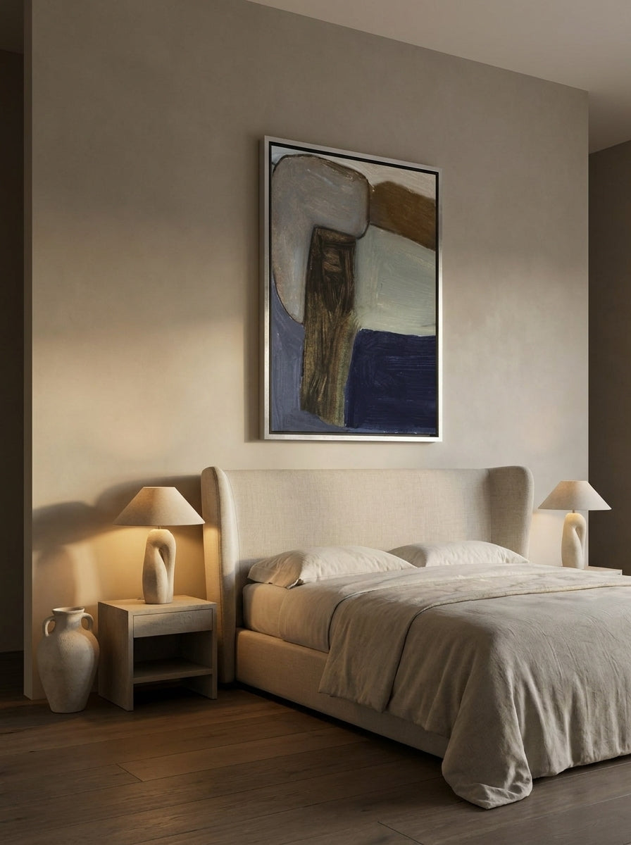 Oversized statement canvas wall art with a silver leaf surround styled on the wall in a luxe bedroom