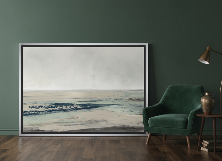 Canvas wall art with a silver leaf surround leaning against the wall in a moody bedroom