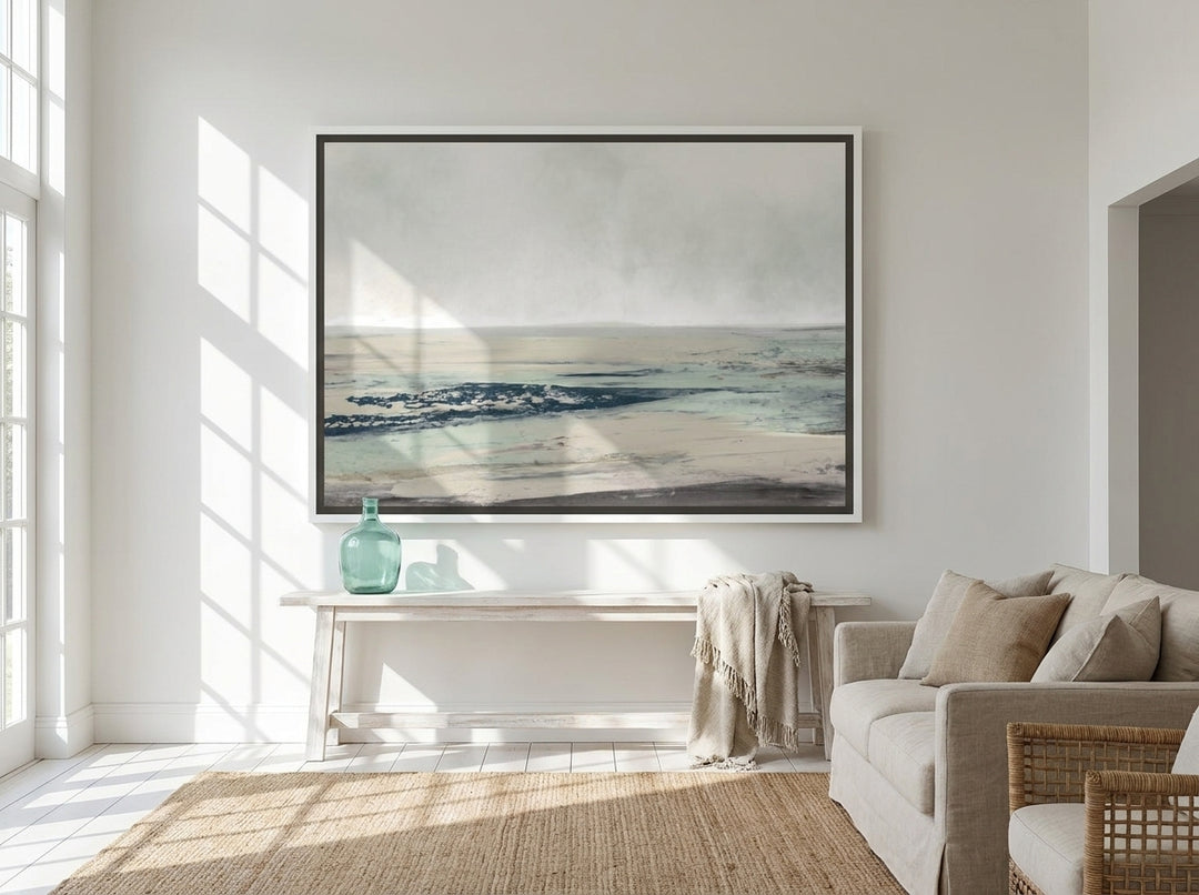 Oversized statement canvas wall art with a white surround styled on the wall in a coastal living room