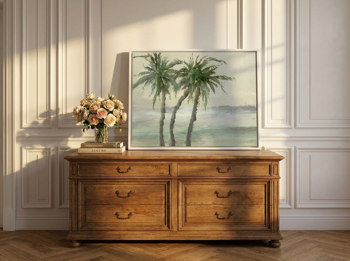 Canvas wall art with a white surround standing on a sideboard in a Parisian home office