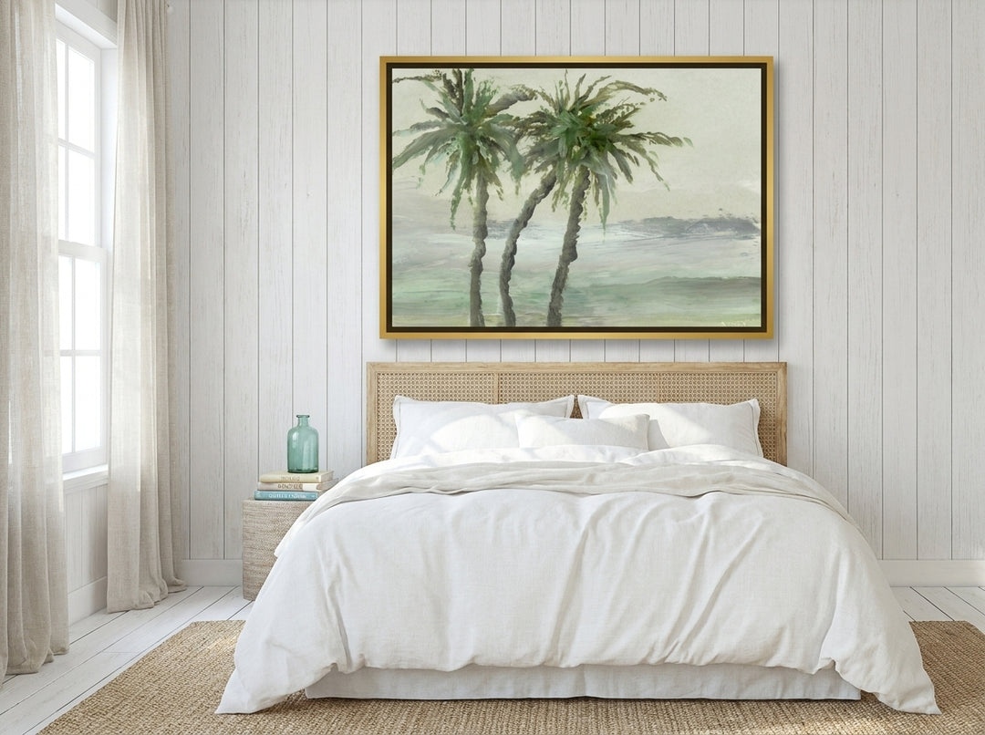 Oversized statement canvas wall art with a gold leaf surround styled on the wall in a coastal bedroom