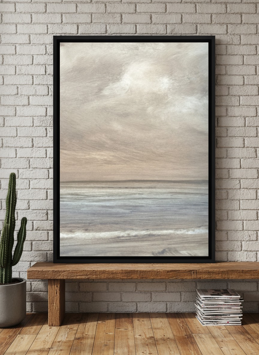 Canvas wall art with a black surround standing on a bench in an industrial loft home office