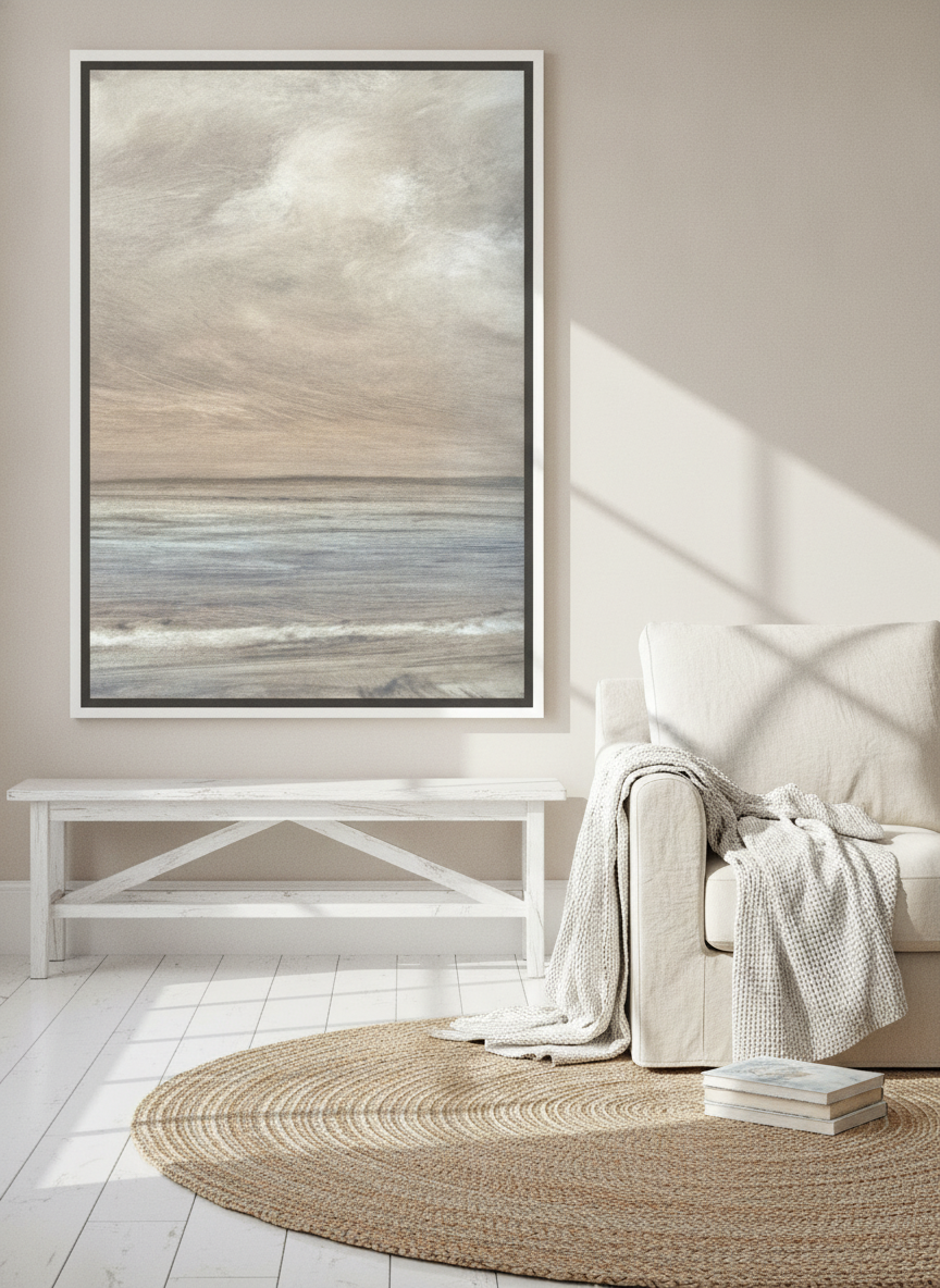 Oversized statement canvas wall art with a white surround styled on the wall in a coastal living room