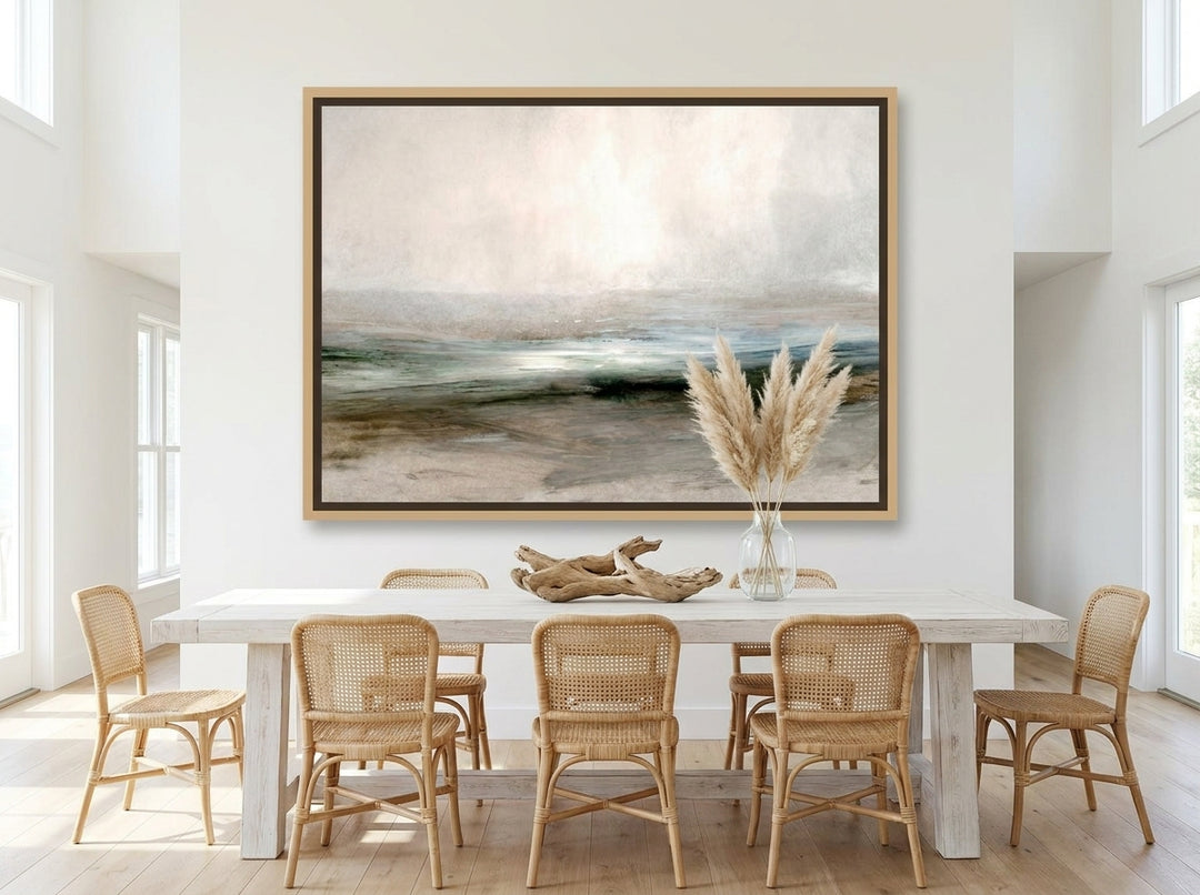 Oversized statement canvas wall art with a natural timber surround styled on the wall in a coastal dining room