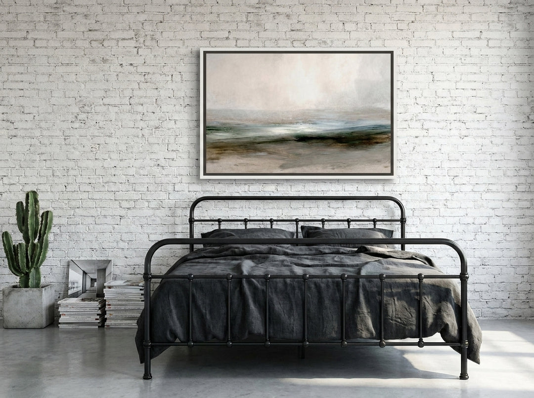 Canvas wall art with a white surround styled on the wall in an industrial loft bedroom