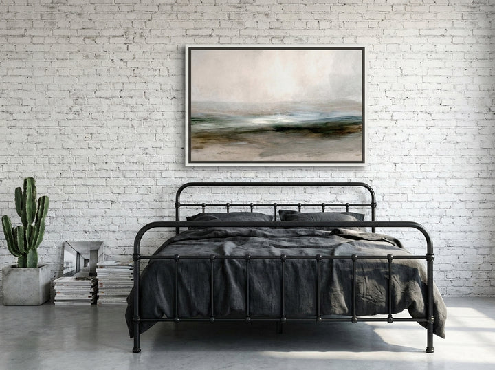 Canvas wall art with a white surround styled on the wall in an industrial loft bedroom
