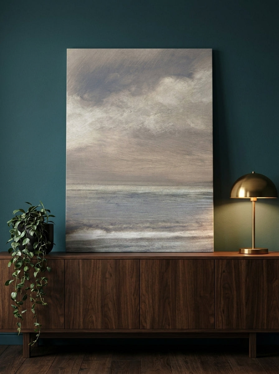 Stretched canvas wall art standing on a sideboard in a moody living room