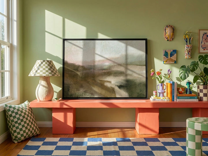 Canvas wall art with a black surround standing on a side table in a colourful eclectic living room