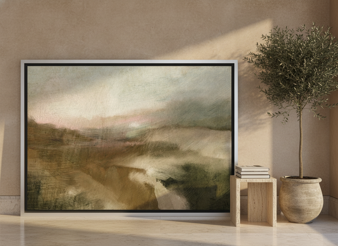 Oversized statement canvas wall art with a silver leaf surround leaning against the wall in a luxe dining room