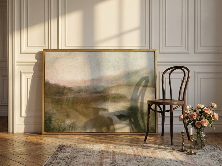 Canvas wall art with a gold leaf surround leaning against the wall in a Parisian home office