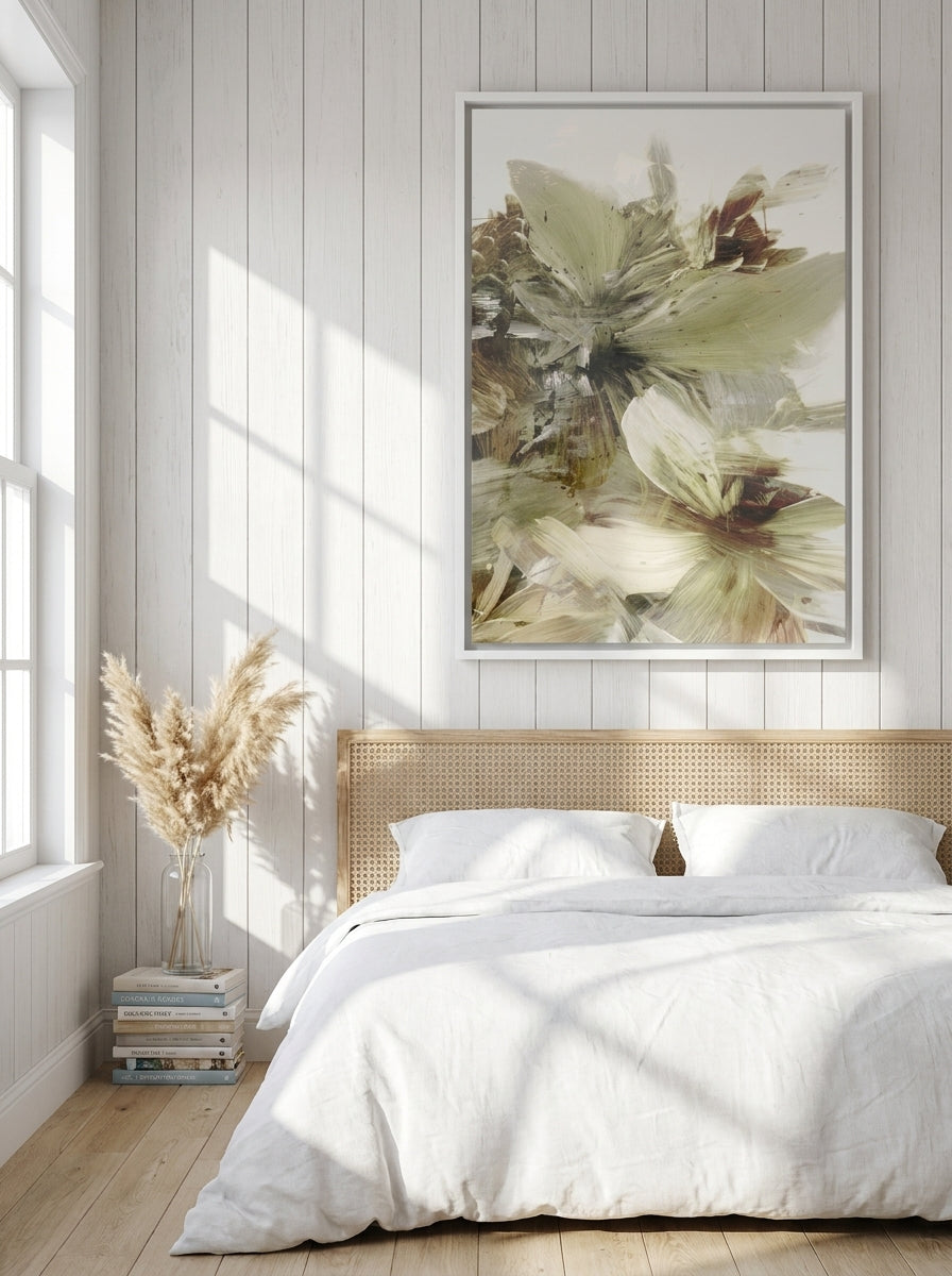 Canvas wall art with a white surround styled on the wall in a coastal bedroom