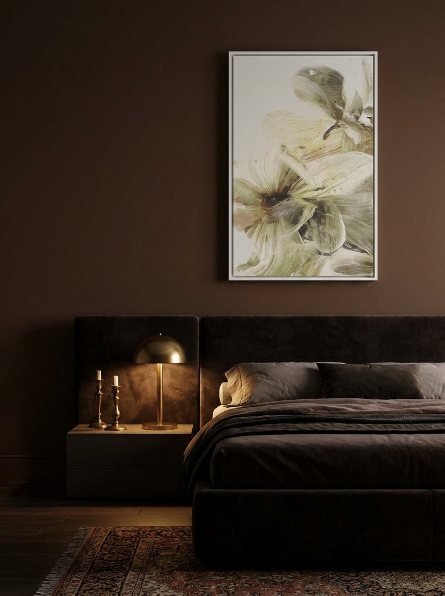 Canvas wall art with a white surround styled on the wall in a moody bedroom