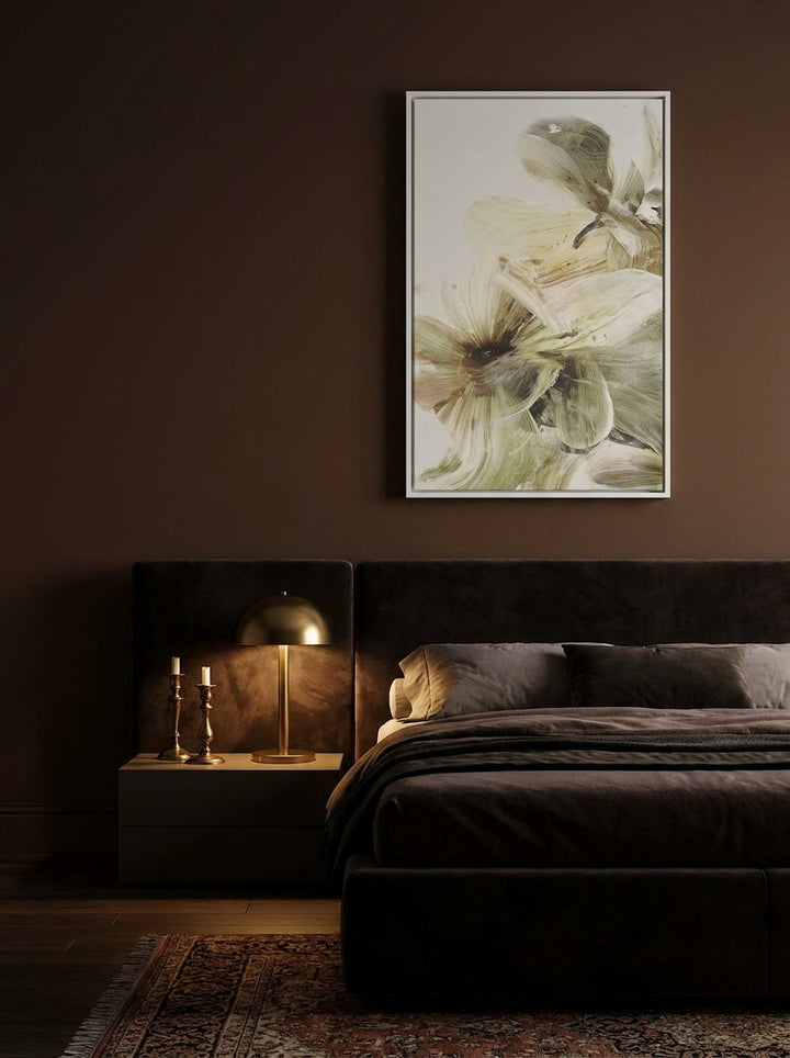 Canvas wall art with a white surround styled on the wall in a moody bedroom