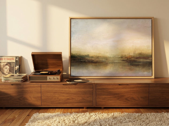 Canvas wall art with a natural timber surround standing on a sideboard in a retro 70s bedroom