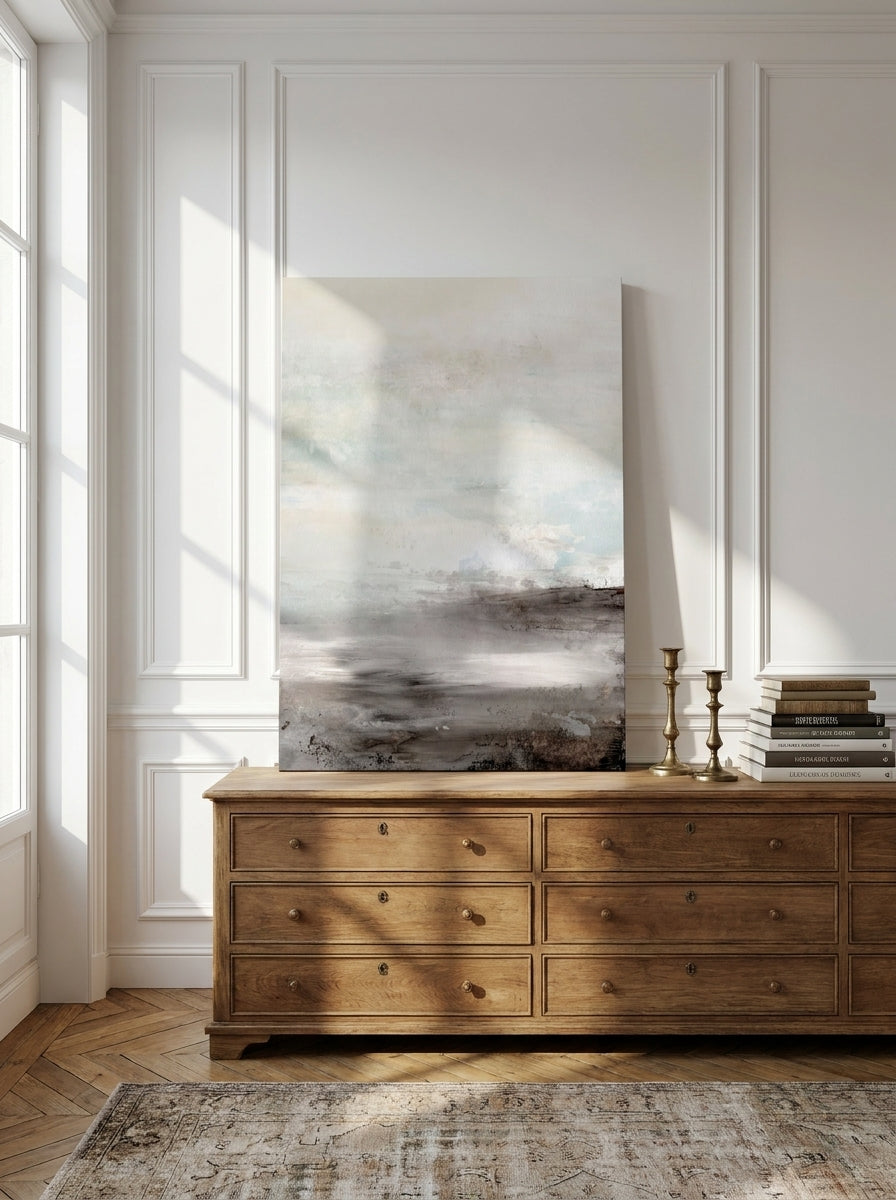 Stretched canvas wall art standing on a sideboard in a Parisian home office
