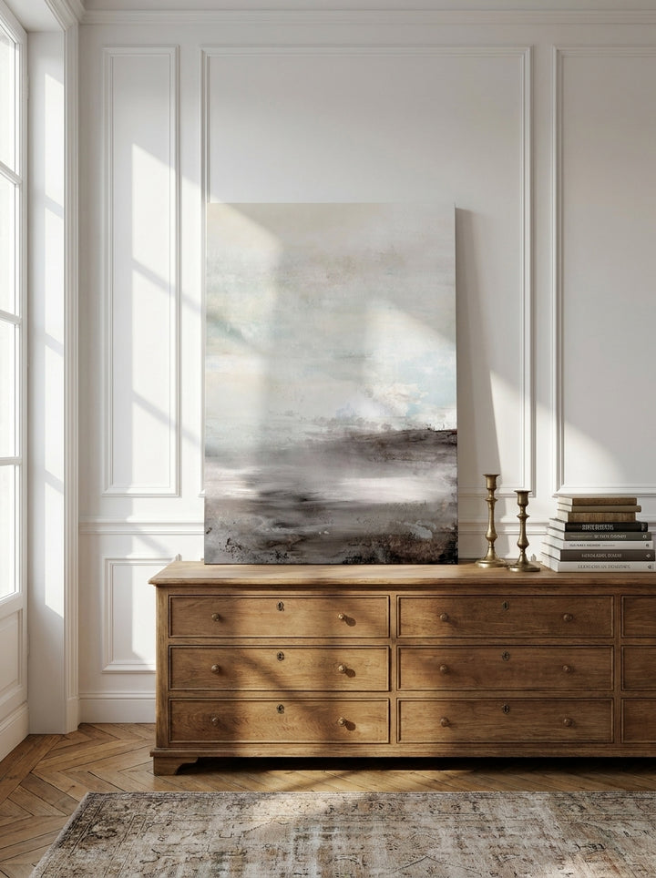 Stretched canvas wall art standing on a sideboard in a Parisian home office
