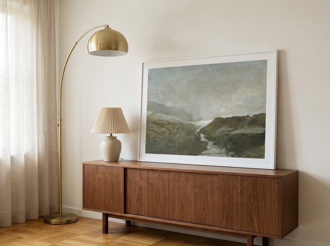 Modern wall art print standing on a sideboard in a mid-century home office