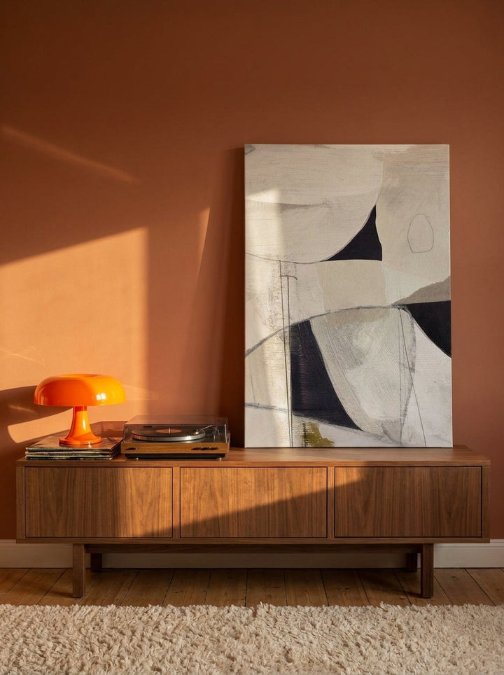 Stretched canvas wall art standing on a sideboard in a retro 70s bedroom