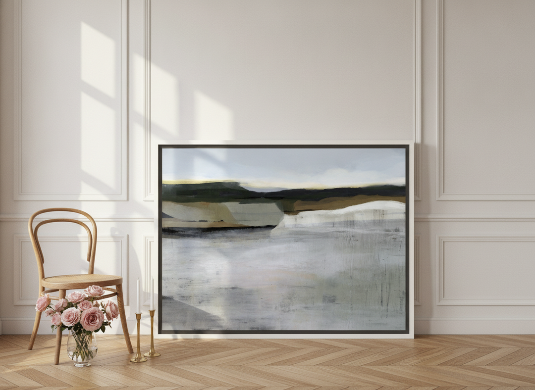 Canvas wall art with a white surround leaning against the wall in a Parisian bedroom