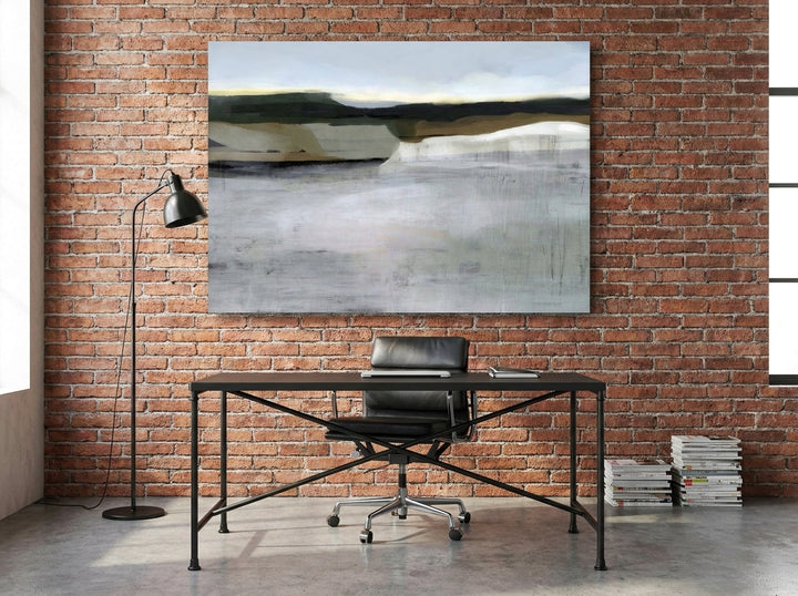 Stretched canvas wall art styled on the wall in an industrial loft home office