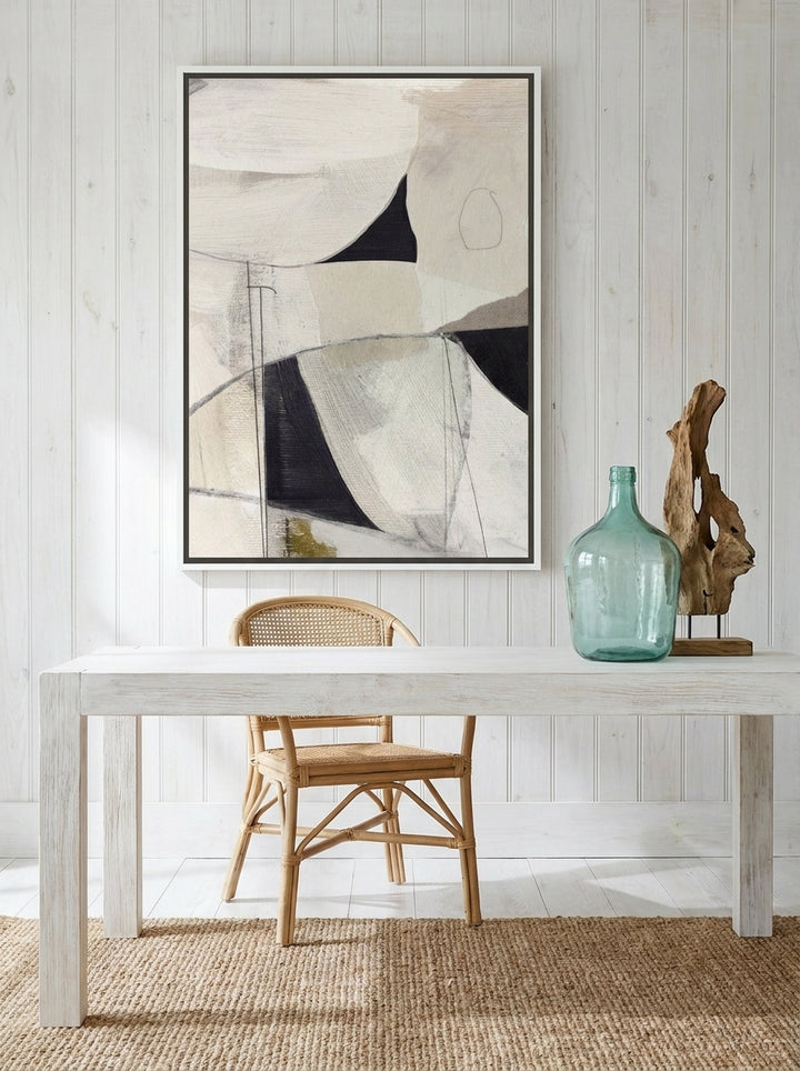 Canvas wall art with a white surround styled on the wall in a coastal home office