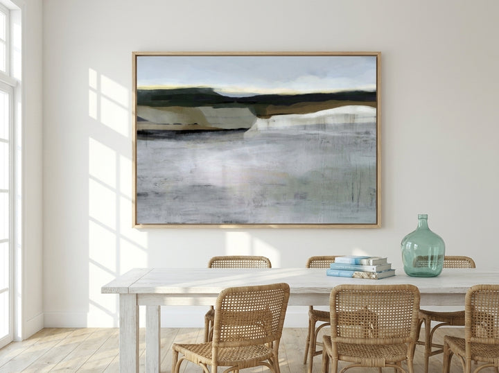 Oversized statement canvas wall art with a natural timber surround styled on the wall in a coastal dining room