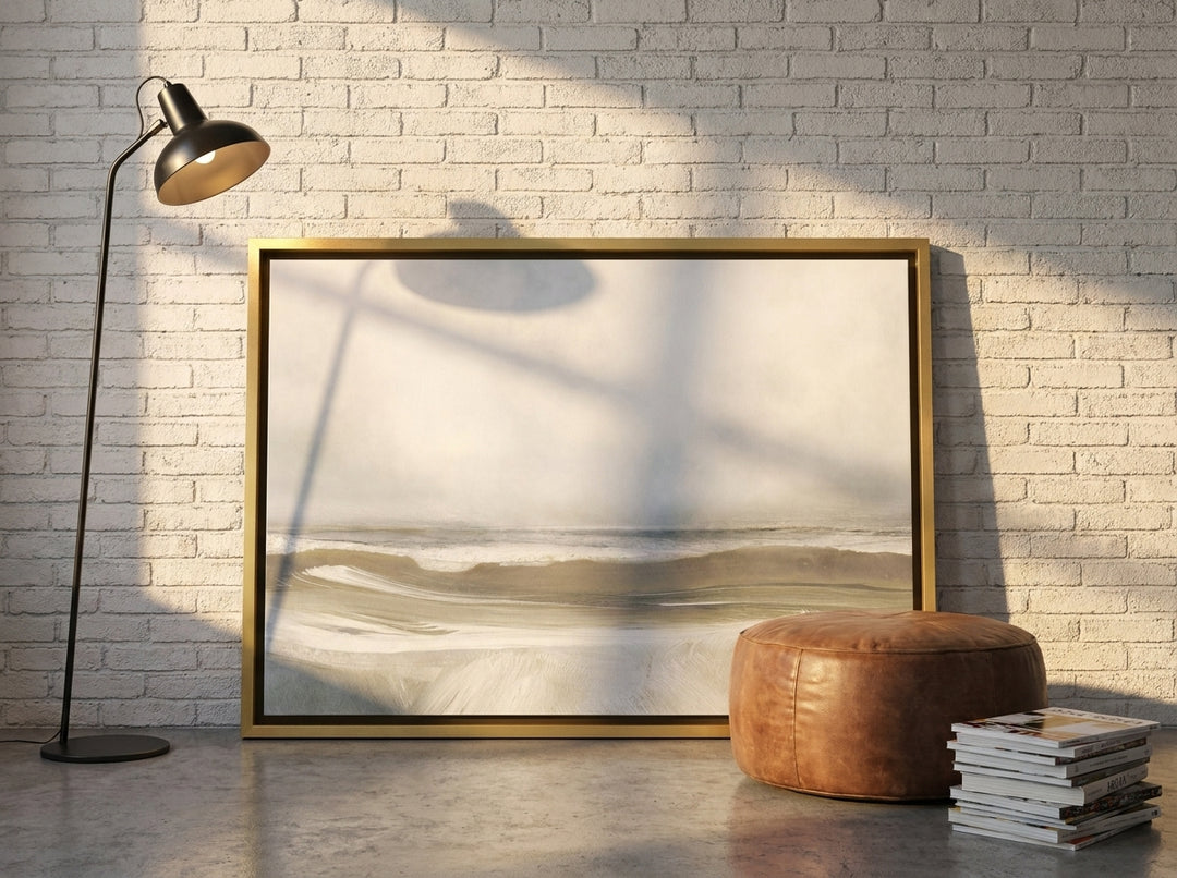 Canvas wall art with a gold leaf surround leaning against the wall in an industrial loft living room