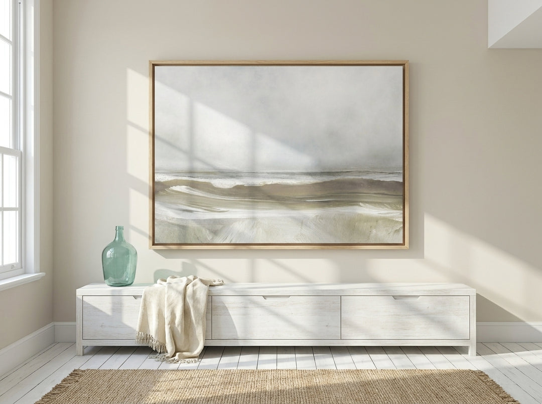 Oversized statement canvas wall art with a natural timber surround styled on the wall in a coastal living room