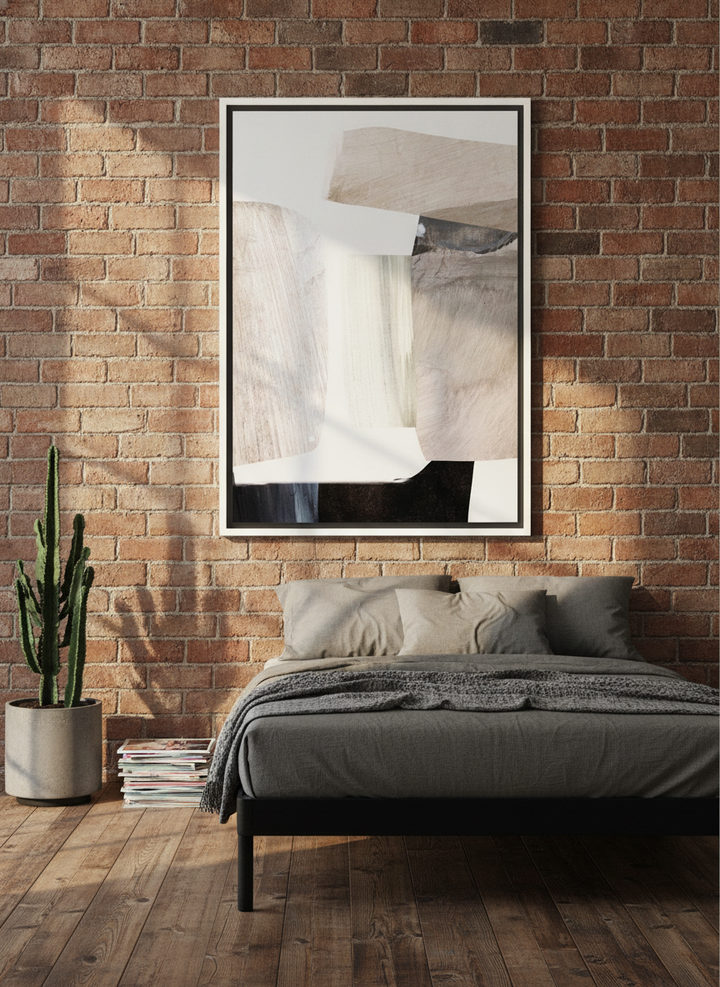 Canvas wall art with a white surround styled on the wall in an industrial loft bedroom