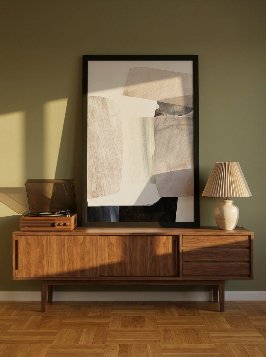 Modern wall art print standing on a sideboard in a mid-century living room