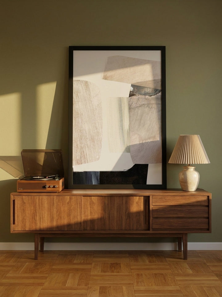 Modern wall art print standing on a sideboard in a mid-century living room