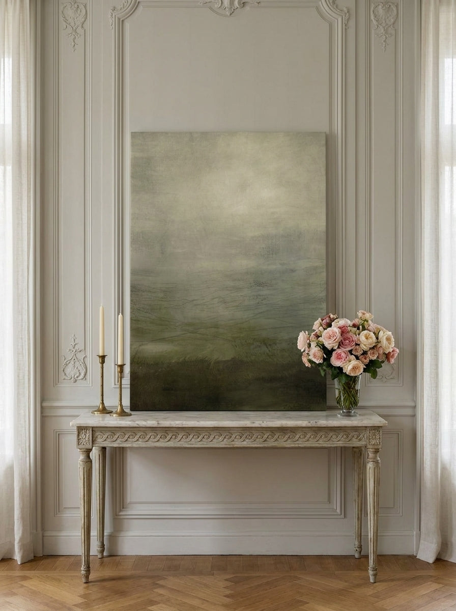 Stretched canvas wall art standing on a console in a Parisian home office