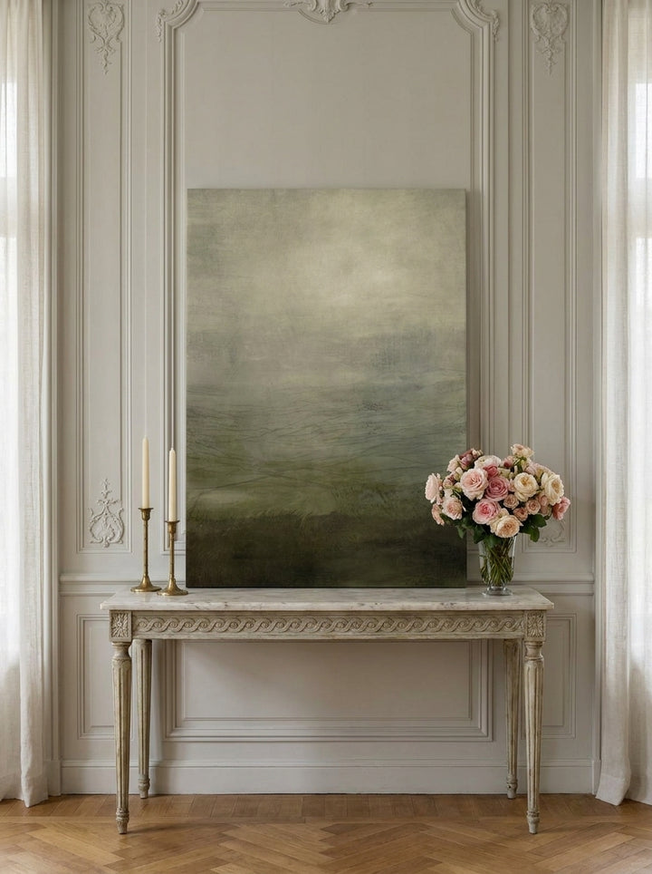 Stretched canvas wall art standing on a console in a Parisian home office