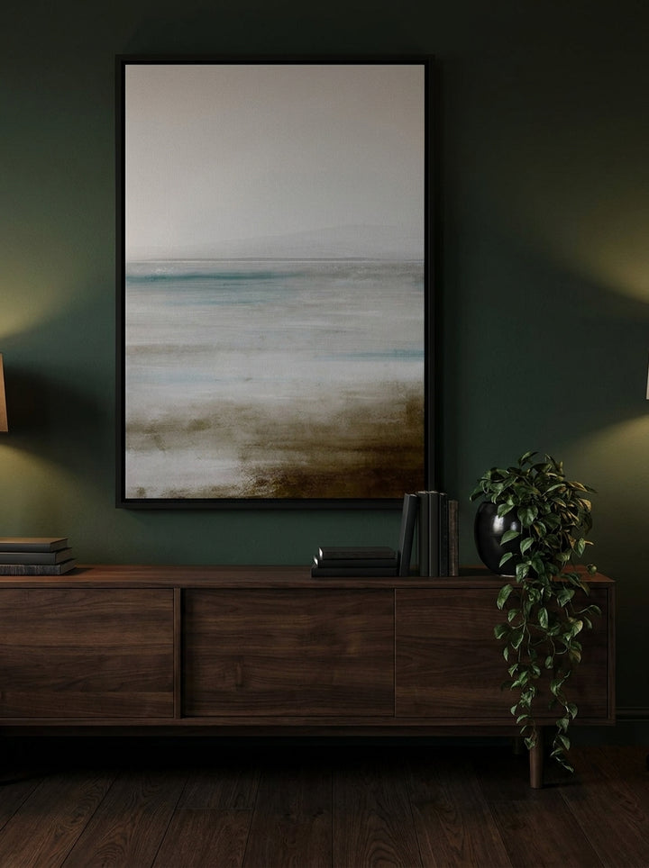 Oversized statement canvas wall art with a black surround styled on the wall in a moody living room