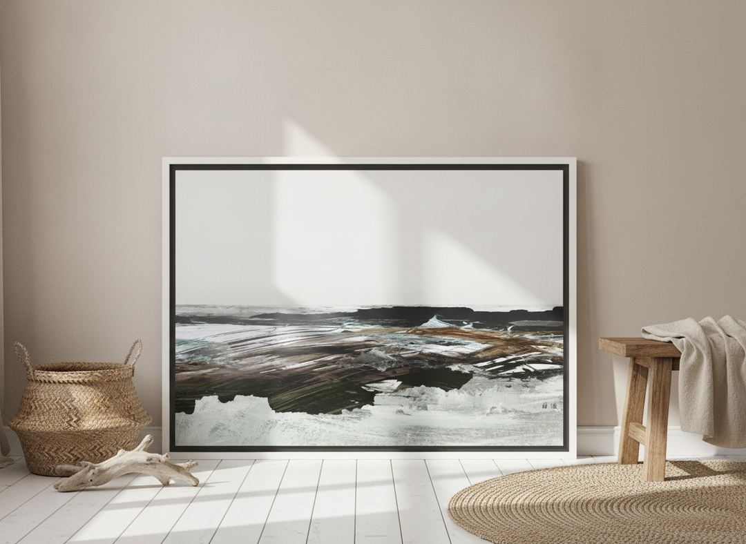 Canvas wall art with a white surround leaning against the wall in a coastal dining room